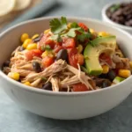 Shredded chicken crockpot dinner with black beans and corn in a bowl