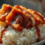 Japanese katsu bowl with crispy pork, rice, cabbage, and tonkatsu sauce