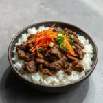 Korean ground beef bowl with rice, carrots, and green onions