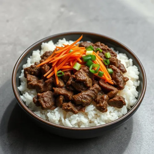 Korean ground beef bowl with rice, carrots, and green onions