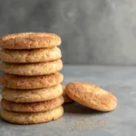 Soft Snickerdoodle cookies stacked on gray concrete background