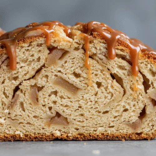 sliced apple fritter bread with diced apples and caramel drizzle