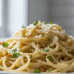 Close-up of creamy garlic Parmesan pasta with parsley garnish