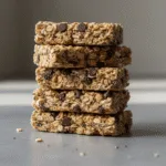 No bake granola bars with oats and chocolate chips stacked closely